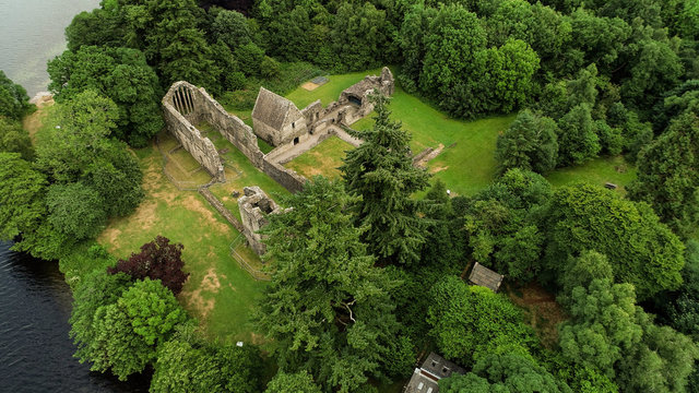Aerial image of the ruins of Inchmahome Priory on a tree covered island on the picturesque Lake of Menteith.