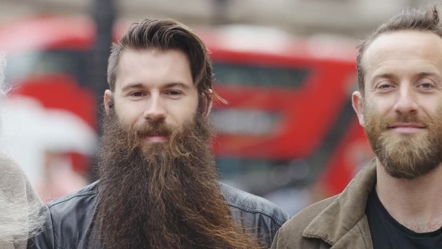 Camera pans across a group of bearded men in the city as they look to camera