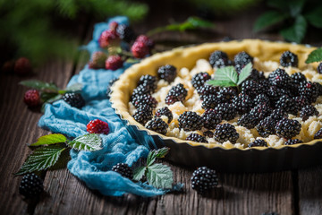 Homemade and sweet tart with blackberries and caster cugar