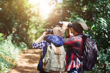 Lovers young with Binoculars and camera in rain Forest, Travel concept, Hiking concept.