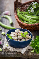 Closeup of tasty broad beans on old wooden table