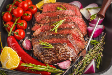 Sliced roast beef in a frying pan with spices and vegetables