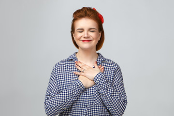 Thank you very much. Picture of emotional happy young stylish female smiling joyfully and closing...
