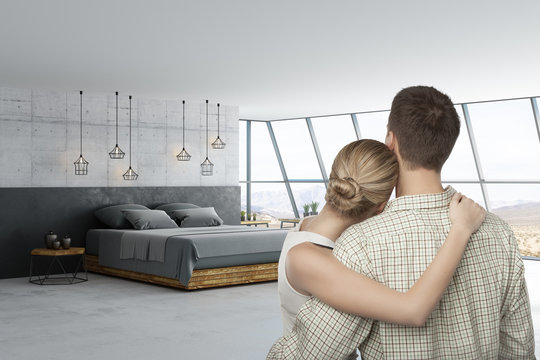 man and woman in loft room with blank poster