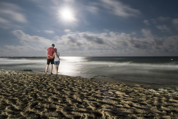 people on a night sea beach