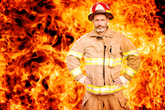 fireman standing in front of wall of fire
