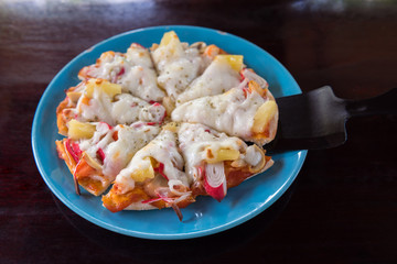 Pizza home made in dish on wooden table