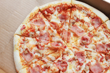 Meat Pizza in Take Away Delivery Box on Empty White Background. Top View of Freshly Baked Sliced Italian Pizza with Chicken, Bacon, Ham and Meat, Top View of Fast Food Italian Pizzeria Menu.
