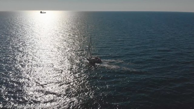 Aerial view of yacht sailing in sea. Boat flowing in sea, travel and vacation concept scene 4K video.