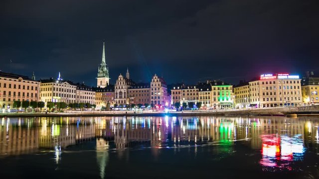 Stockholm Old Town buildings 4K Time Lapse Tilt. Gamla stan cityscape skyline at night, beautiful water reflections. Capital city of Sweden