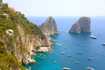 Fototapeta premium Stunning view of Capri island in a beautiful summer day with Faraglioni rocks Capri, Italy