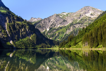 Fototapeta na wymiar Scenic view Of Lake Vilsalpsee and mountains against sky, Tannheimer Valley, Tyrol, Austria