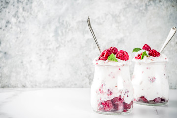 Healthy breakfast, cream dessert, frozen yogurt with fresh raspberries, raspberry jam, served with...