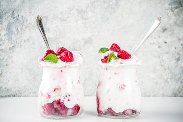 Healthy breakfast, cream dessert, frozen yogurt with fresh raspberries, raspberry jam, served with...