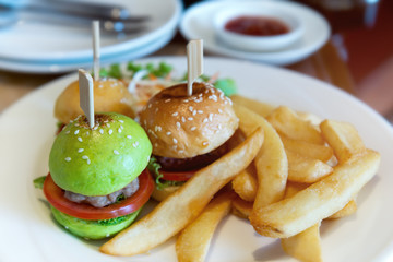 Mini burger set in white plate.