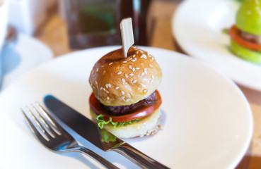 Mini burger set in white plate.