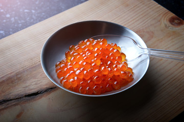 Salmon roe in metal cup.