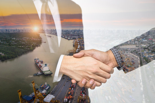 Double Exposure Of A Businessman Handshake On The Container,container Ship In Import Export And Business Logistic,By Crane ,Trade Port , Shipping,cargo To Harbor Background.