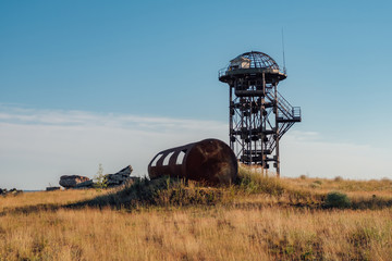 Fototapeta premium Old rusty iron abandoned watch tower in wastelands 
