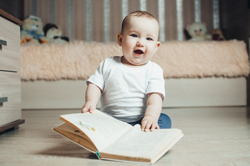 little girl sitting on the floor with a book