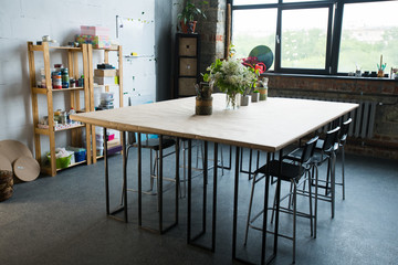 Interior shot of modern design apartment with white  metal and wood table, copy space