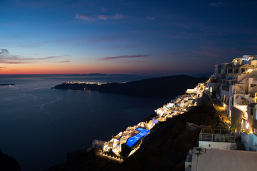 Fototapeta na wymiar Whitewashed Houses with View onto Sea and Oia during Sunset in Imerovigli, Santorini, Greece