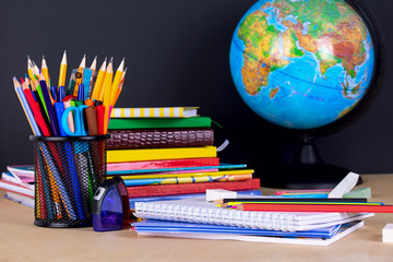 School supplies on blackboard background with copy space.
