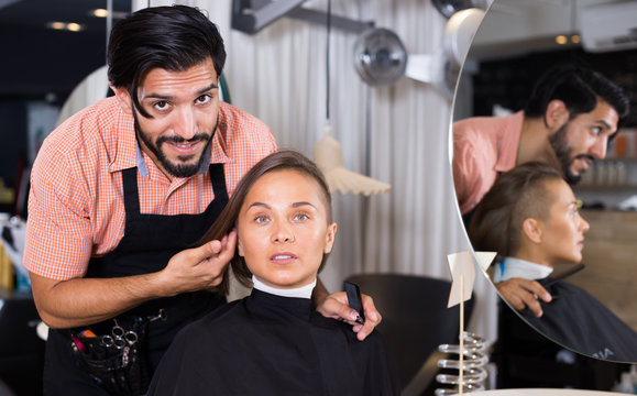 male hairdresser and female in beauty salon