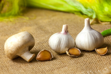 garlic and mushrooms close-up lie on the burlap
