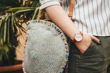 street style fashion details. close up, woman wearing a summer shirt and a white and brown analog...