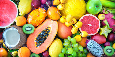 Assortment of colorful ripe tropical fruits. Top view - obrazy, fototapety, plakaty