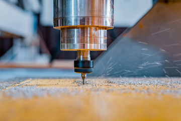 Turning and milling machine with CNC. Closeup of a spindle with a cutter during milling of the workpiece.