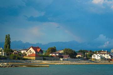 Fototapeta na wymiar Picturesque seashore village under dramatic sky
