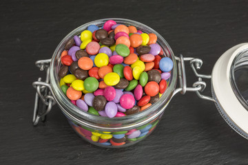 multicolored sugar coated candies in a glass jar