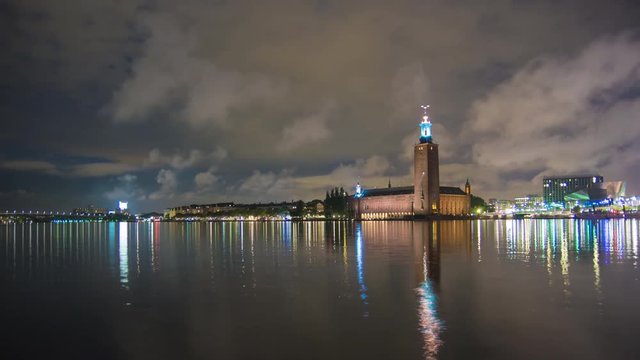 4K Time Lapse of Stockholm City Hall building at night. Town Hall famous landmark, nobel prize award ceremony. Beautiful water reflections, Capital city of Sweden