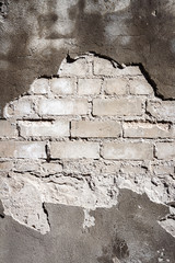 Old gray brick and plaster wall texture background