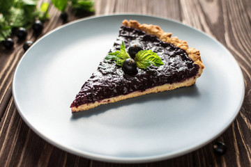 Homemade summer berry tart on a wooden background