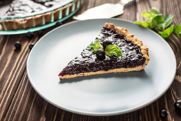 Homemade summer berry tart on a wooden background