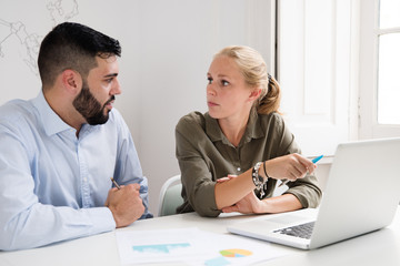 Fototapeta premium Man and woman looking at each other at a desk