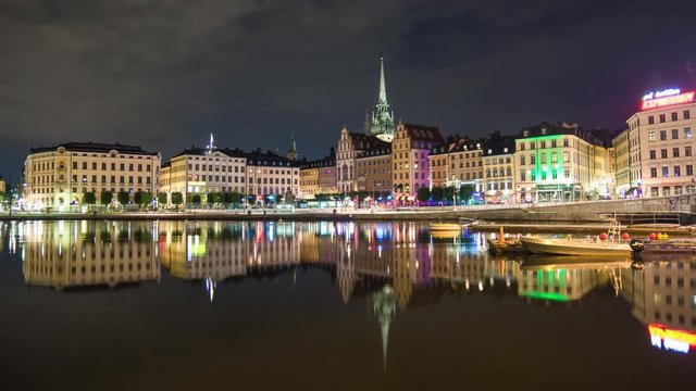 Stockholm Gamla stan buildings 4K Time Lapse. Old Town cityscape skyline at night, beautiful calm water reflections. Capital city of Sweden