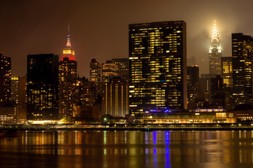 Fototapeta na wymiar Manhattan skyline at night with reflections, NYC, USA.