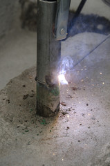 welds of a railing during the renovation of a roof in the evening in Italy