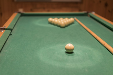 billiard table with balls and cue stick. gambling table with russian billiard set and cue