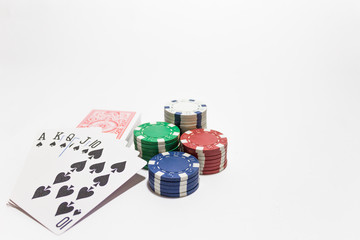 Hand of poker, Royal flush of spades, chips on white background.