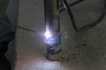 welds of a railing during the renovation of a roof in the evening in Italy