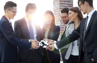 Group of business people assembling jigsaw puzzle, team support 