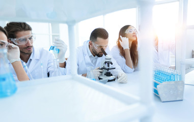 background image is a group of scientists working in the laboratory.