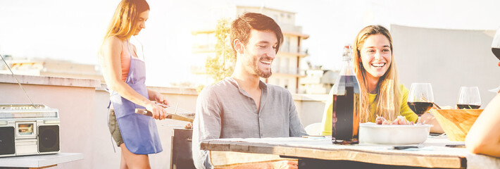 Happy friends having fun at patio barbecue dinner party