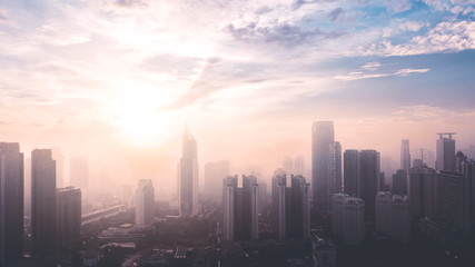 Fototapeta na wymiar Jakarta cityscape with air pollution at sunrise time