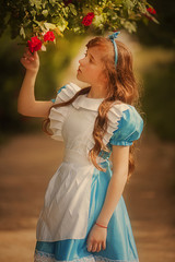 Girl in fairy tale park with tree in spring